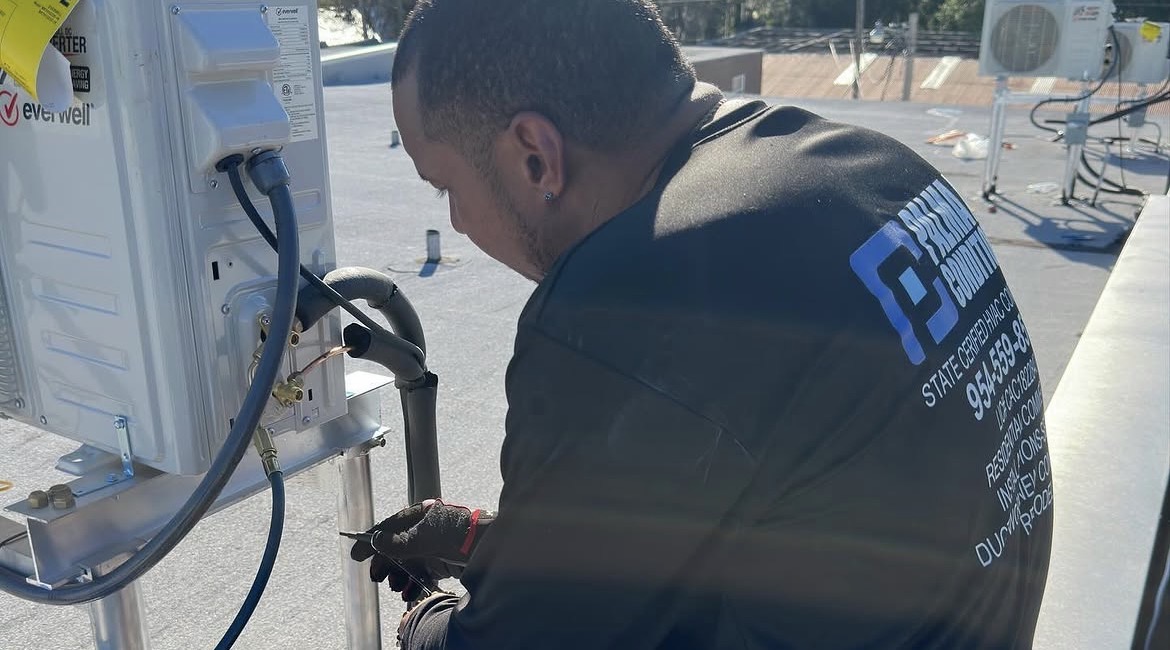 Palma Air technician servicing rooftop HVAC equipment